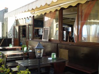 The external view of Déjà Vu pub with the platform directly on the Via Marco Polo